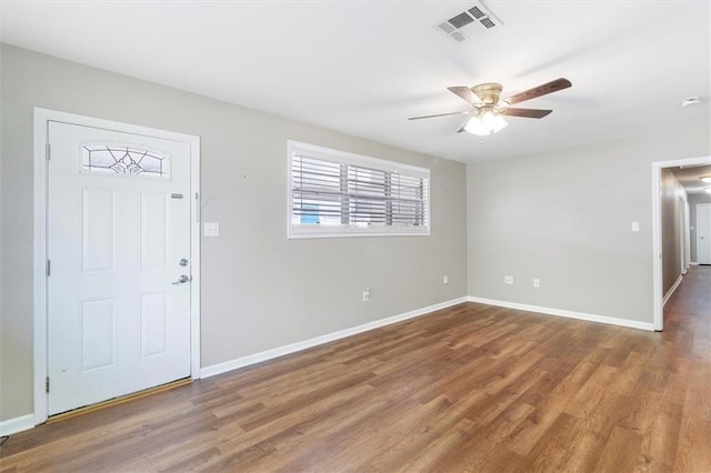 entrance foyer with wood finished floors, visible vents, a ceiling fan, and baseboards