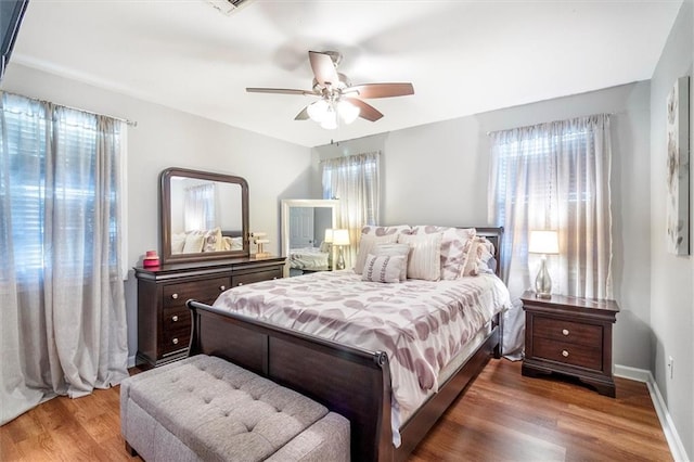 bedroom featuring baseboards, a ceiling fan, and wood finished floors