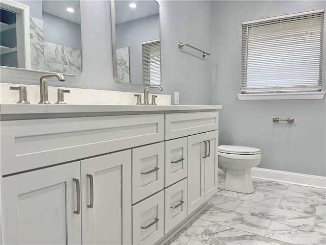full bathroom with double vanity, baseboards, toilet, recessed lighting, and marble finish floor