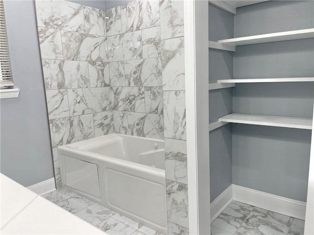 full bath with baseboards, bathtub / shower combination, and marble finish floor