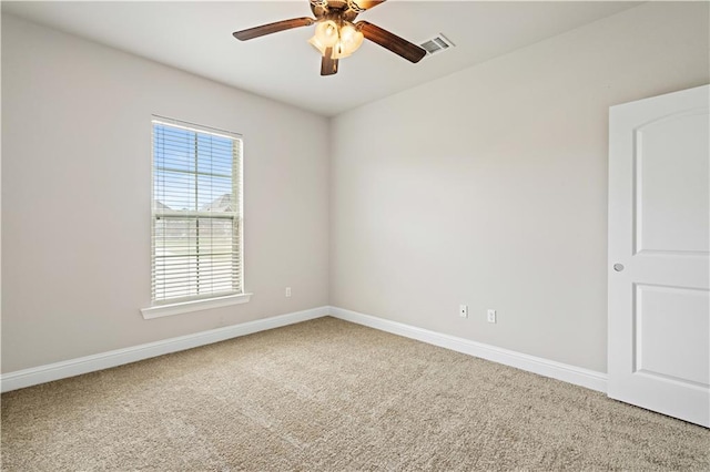 spare room featuring baseboards, visible vents, carpet, and ceiling fan
