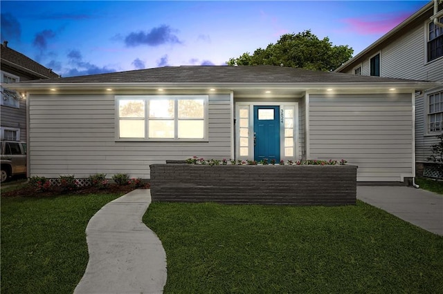 3824 Nashville Ave, New Orleans, LA 70125 - ranch-style home with concrete driveway, roof with shingles, a front lawn, and a garage