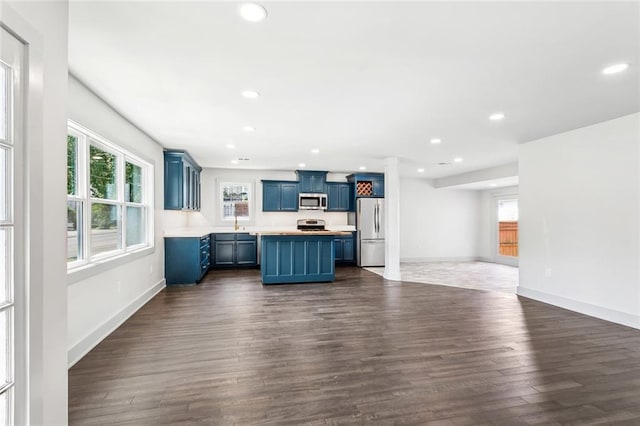 3824 Nashville Ave, New Orleans, LA 70125 - kitchen featuring appliances with stainless steel finishes, a center island, blue cabinets, and recessed lighting