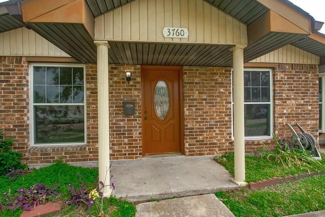 3760 W Louisiana State Dr, Kenner, LA 70065 - view of exterior entry with board and batten siding, covered porch, and brick siding