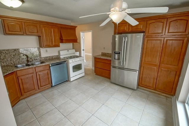 3760 W Louisiana State Dr, Kenner, LA 70065 - kitchen featuring a ceiling fan, a sink, premium range hood, brown cabinetry, and appliances with stainless steel finishes