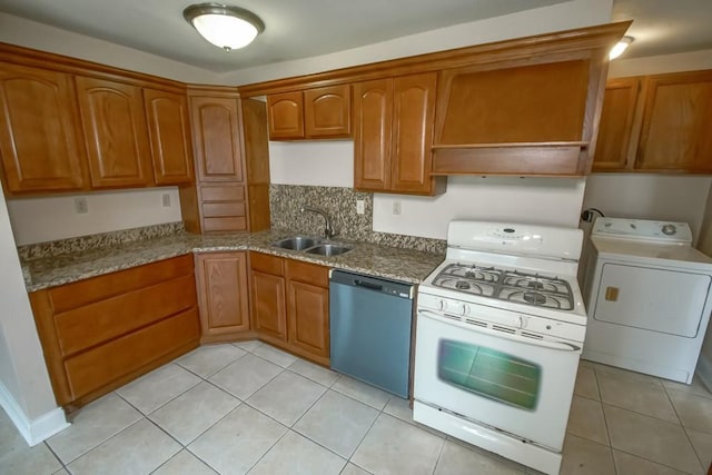 3760 W Louisiana State Dr, Kenner, LA 70065 - kitchen featuring dishwasher, a sink, washer / dryer, white gas stove, and brown cabinetry