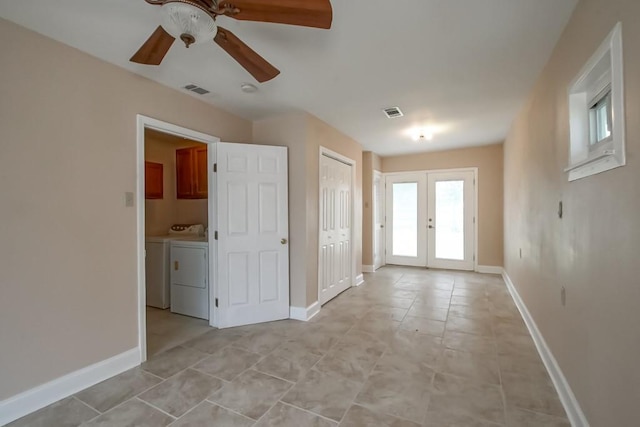 3760 W Louisiana State Dr, Kenner, LA 70065 - spare room featuring visible vents, a ceiling fan, french doors, washing machine and dryer, and baseboards