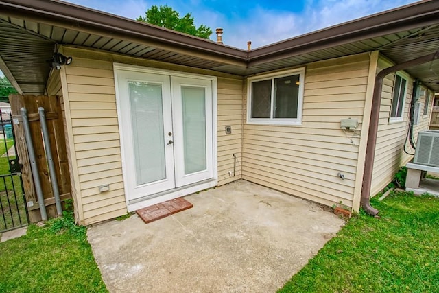 3760 W Louisiana State Dr, Kenner, LA 70065 - property entrance with fence, a patio area, french doors, and cooling unit