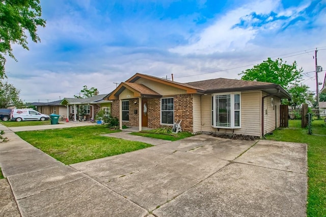 3760 W Louisiana State Dr, Kenner, LA 70065 - ranch-style house with fence, a front lawn, brick siding, and a gate