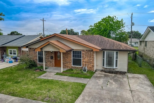 3760 W Louisiana State Dr, Kenner, LA 70065 - bungalow-style house featuring brick siding, a shingled roof, a front lawn, and fence