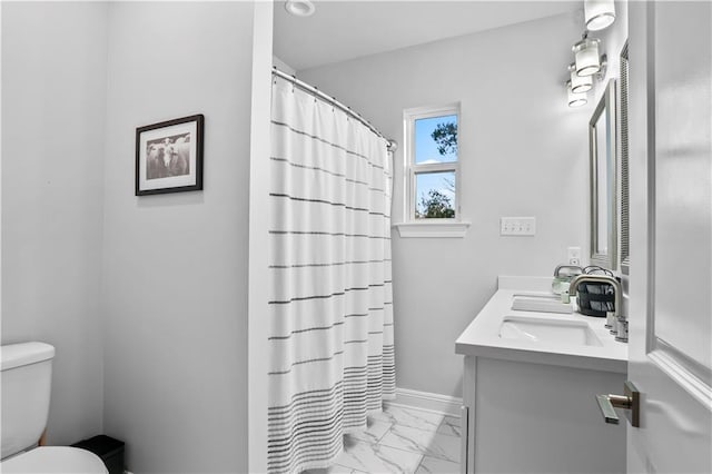 bathroom with a shower with curtain, baseboards, toilet, vanity, and marble finish floor