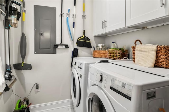 laundry room featuring washer and clothes dryer, electric panel, marble finish floor, cabinet space, and baseboards