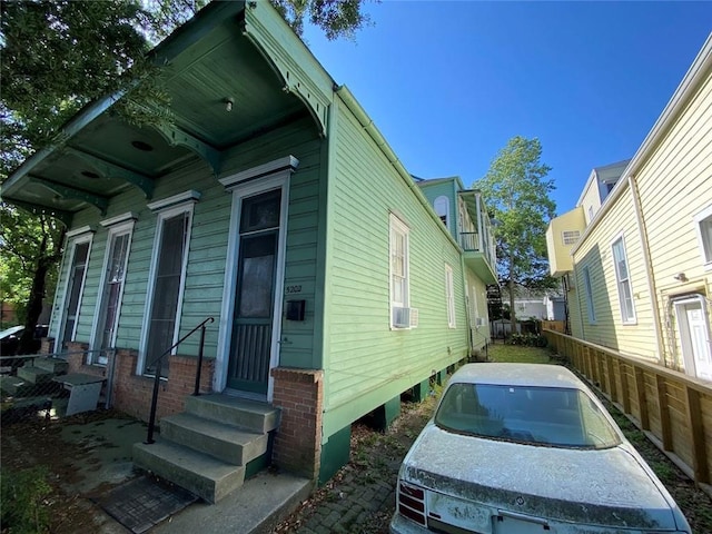 520002 Magazine St, New Orleans, LA 70115 - view of side of home with entry steps and cooling unit