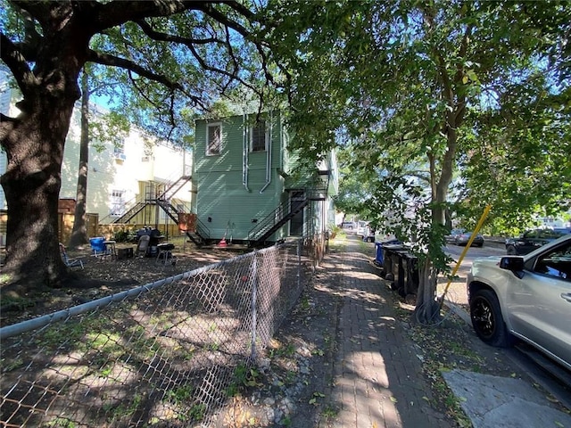520002 Magazine St, New Orleans, LA 70115 - view of side of home featuring stairway