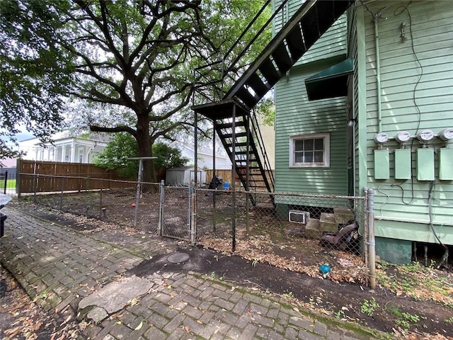 520002 Magazine St, New Orleans, LA 70115 - view of property exterior with stairs, a gate, and a shed