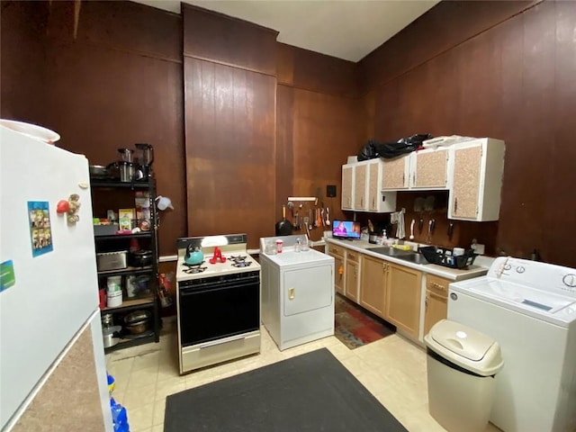 520002 Magazine St, New Orleans, LA 70115 - kitchen with washer / clothes dryer, white appliances, light countertops, and light floors