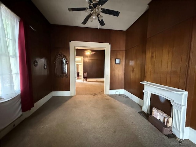 520002 Magazine St, New Orleans, LA 70115 - unfurnished living room with a ceiling fan, carpet flooring, baseboards, wooden walls, and a fireplace