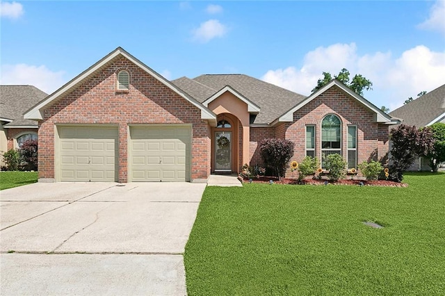ranch-style home featuring driveway, a garage, brick siding, a shingled roof, and a front yard