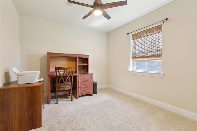 office space with ceiling fan, light carpet, and baseboards