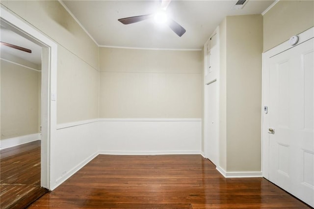 interior space featuring wood-type flooring, visible vents, baseboards, and ornamental molding