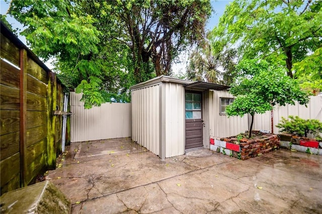 view of outbuilding featuring a fenced backyard and an outdoor structure