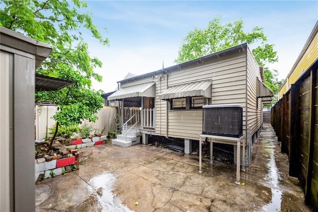 back of property featuring fence and a patio area