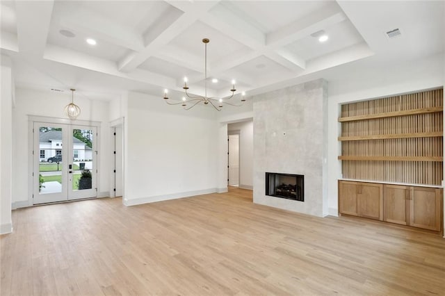 unfurnished living room with light wood-type flooring, baseboards, visible vents, a chandelier, and coffered ceiling