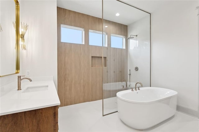 bathroom with vanity, a freestanding bath, and a shower with shower door