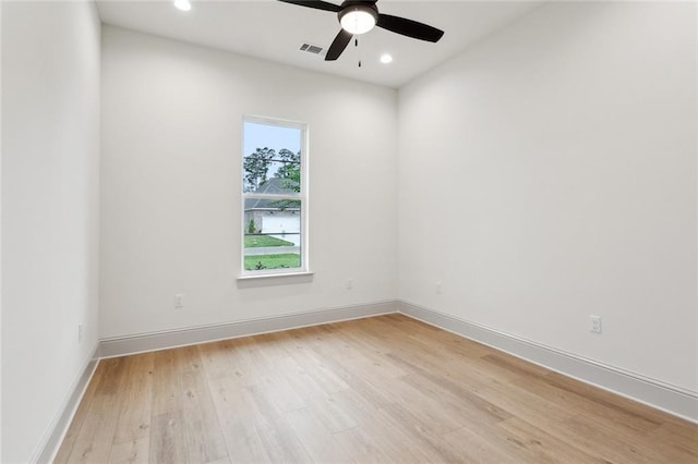 empty room with baseboards, a ceiling fan, light wood-style floors, and recessed lighting