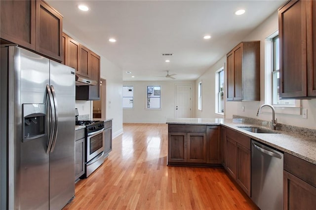 2900 General Taylor St, New Orleans, LA 70115 - kitchen with a sink, light wood finished floors, under cabinet range hood, stainless steel appliances, and recessed lighting