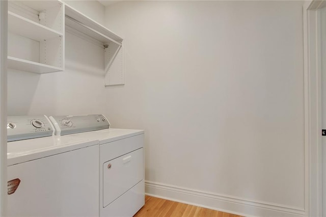 2900 General Taylor St, New Orleans, LA 70115 - laundry room with laundry area, light wood-type flooring, baseboards, and washing machine and clothes dryer