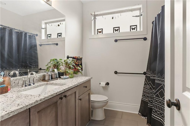 2900 General Taylor St, New Orleans, LA 70115 - full bath with a shower with curtain, tile patterned flooring, vanity, baseboards, and toilet