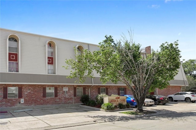 view of building exterior featuring uncovered parking