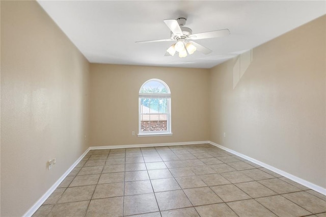 spare room featuring baseboards, ceiling fan, and light tile patterned flooring