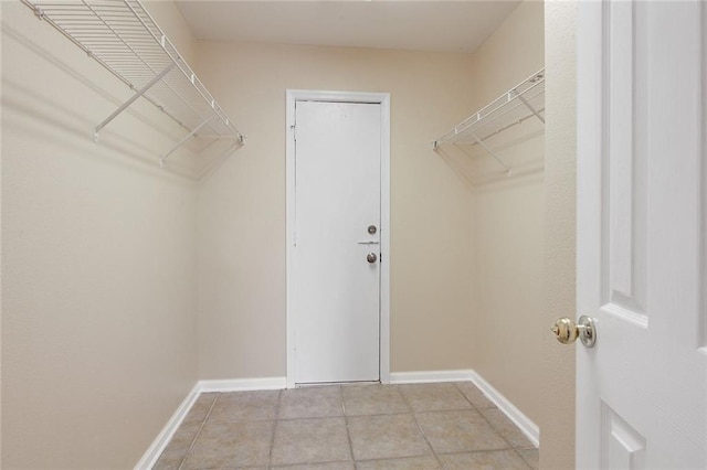 spacious closet featuring light tile patterned floors