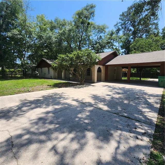 34084 Reilly Rd, Slidell, LA 70460 - view of front of home with a carport, a front lawn, and concrete driveway