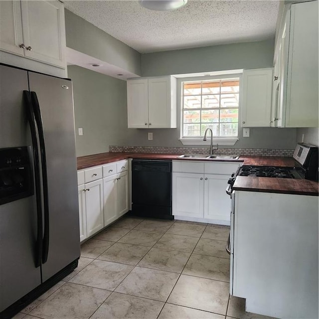 34084 Reilly Rd, Slidell, LA 70460 - kitchen featuring a textured ceiling, a sink, white cabinetry, and stainless steel appliances