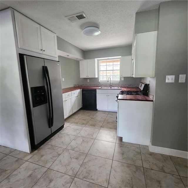 34084 Reilly Rd, Slidell, LA 70460 - kitchen featuring appliances with stainless steel finishes, a textured ceiling, visible vents, and a sink