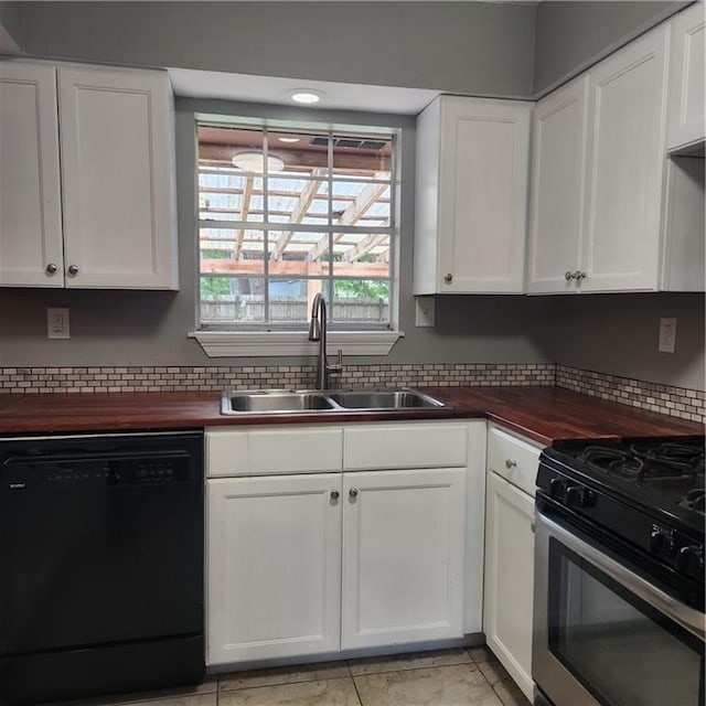 34084 Reilly Rd, Slidell, LA 70460 - kitchen with a sink, wood counters, black dishwasher, stainless steel gas stove, and white cabinets