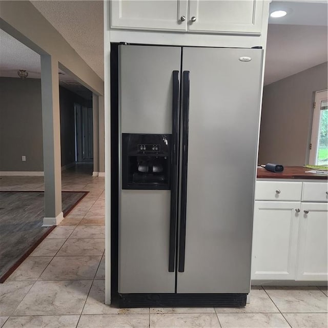 34084 Reilly Rd, Slidell, LA 70460 - kitchen with white cabinetry, stainless steel fridge, and baseboards