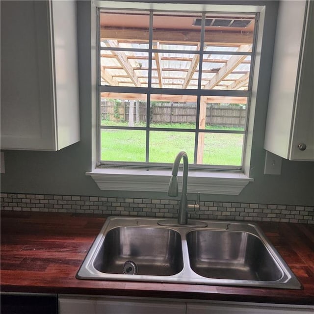 34084 Reilly Rd, Slidell, LA 70460 - interior details with dark countertops, backsplash, and a sink