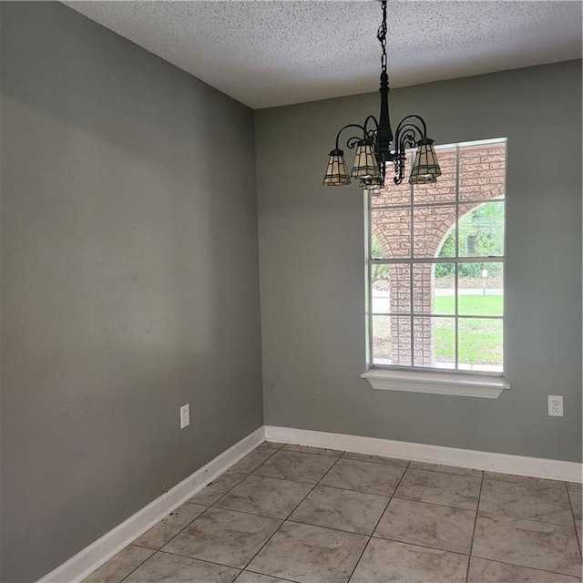 34084 Reilly Rd, Slidell, LA 70460 - unfurnished dining area featuring baseboards, an inviting chandelier, and a textured ceiling