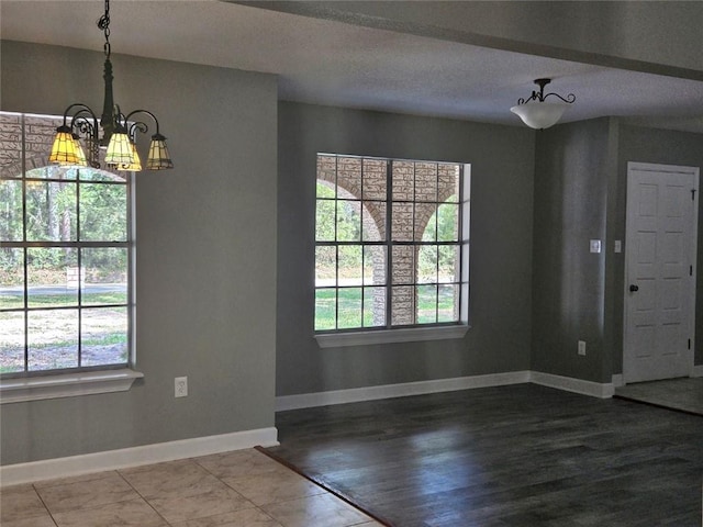 34084 Reilly Rd, Slidell, LA 70460 - unfurnished dining area featuring baseboards, wood finished floors, a chandelier, and plenty of natural light