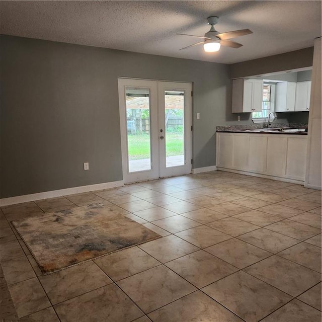 34084 Reilly Rd, Slidell, LA 70460 - interior space with light tile patterned floors, ceiling fan, baseboards, a textured ceiling, and french doors