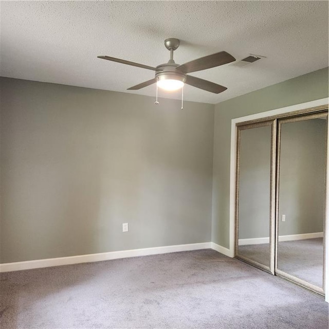 34084 Reilly Rd, Slidell, LA 70460 - unfurnished bedroom featuring carpet floors, a closet, baseboards, visible vents, and a textured ceiling