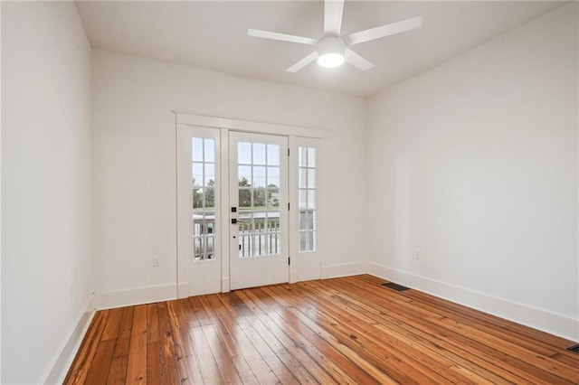 720 Moss St, New Orleans, LA 70119 - empty room with hardwood / wood-style flooring, baseboards, and a ceiling fan