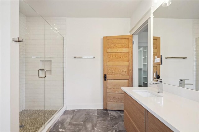 720 Moss St, New Orleans, LA 70119 - full bathroom with marble finish flooring, a shower stall, vanity, and a walk in closet