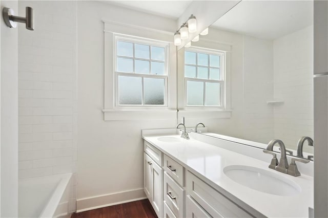 720 Moss St, New Orleans, LA 70119 - full bath featuring wood finished floors, baseboards, and double vanity