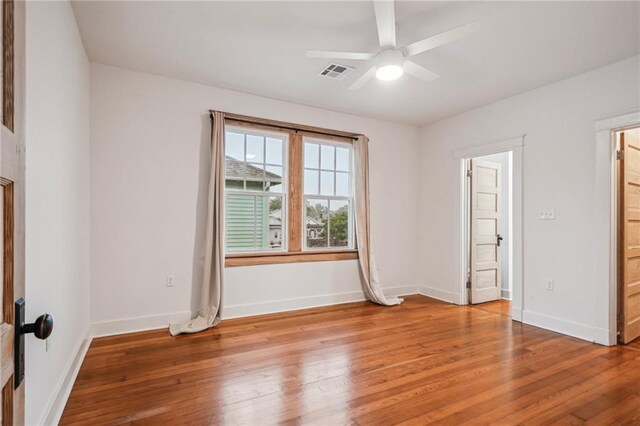 720 Moss St, New Orleans, LA 70119 - unfurnished bedroom with light wood-style flooring, ensuite bathroom, and ceiling fan