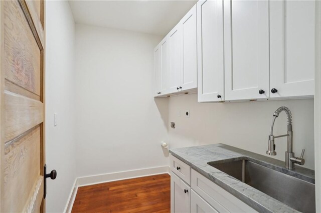 720 Moss St, New Orleans, LA 70119 - laundry area with cabinet space, dark wood-style floors, and electric dryer hookup